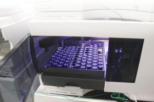 Vials of wastewater samples are placed in a liquid chromatograph to determine the concentration of target contaminants. This is a conventional chemical analysis. Credit: Eve Krakow.